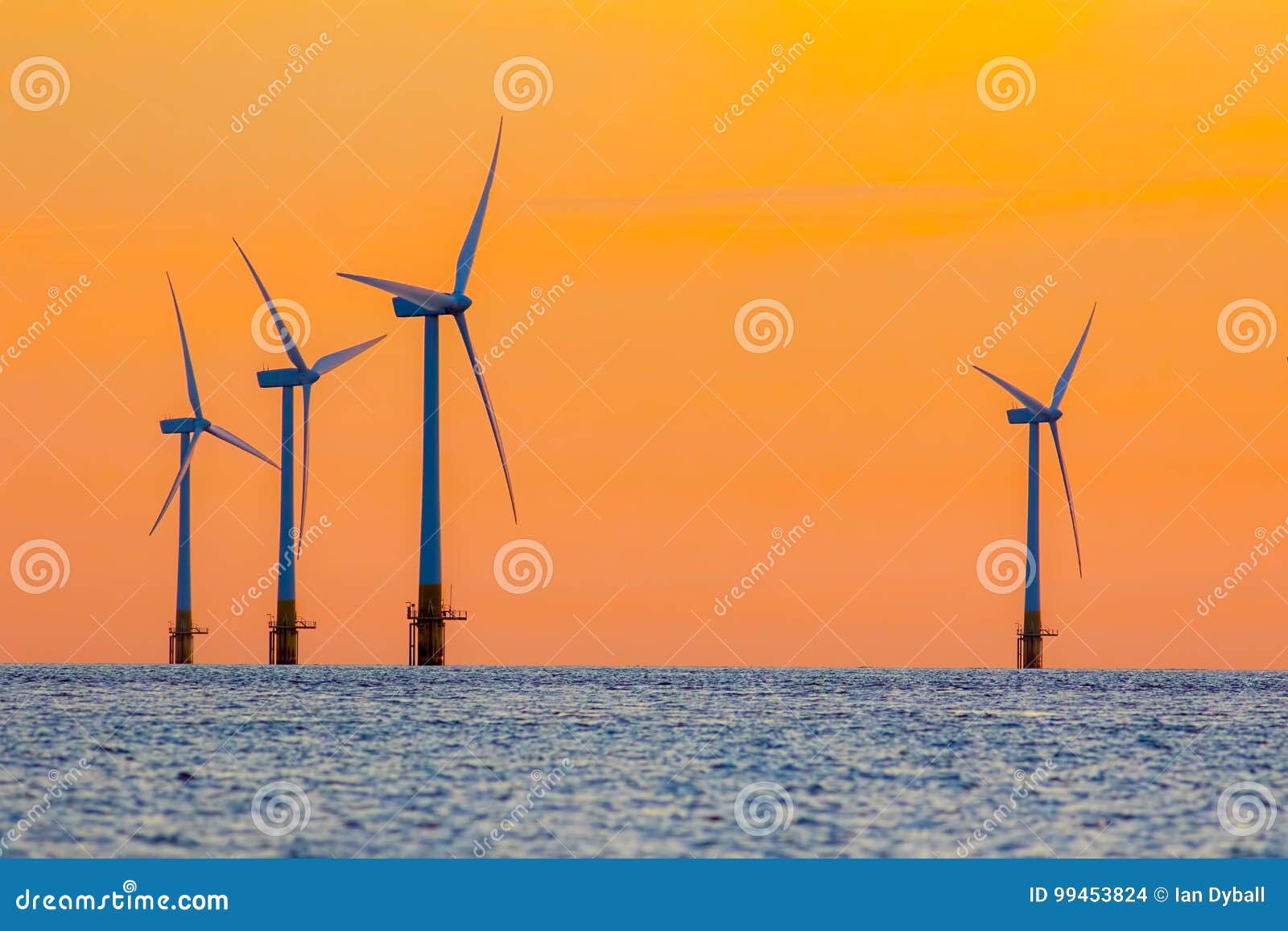 offshore wind farm energy turbines at dawn. surreal but natural