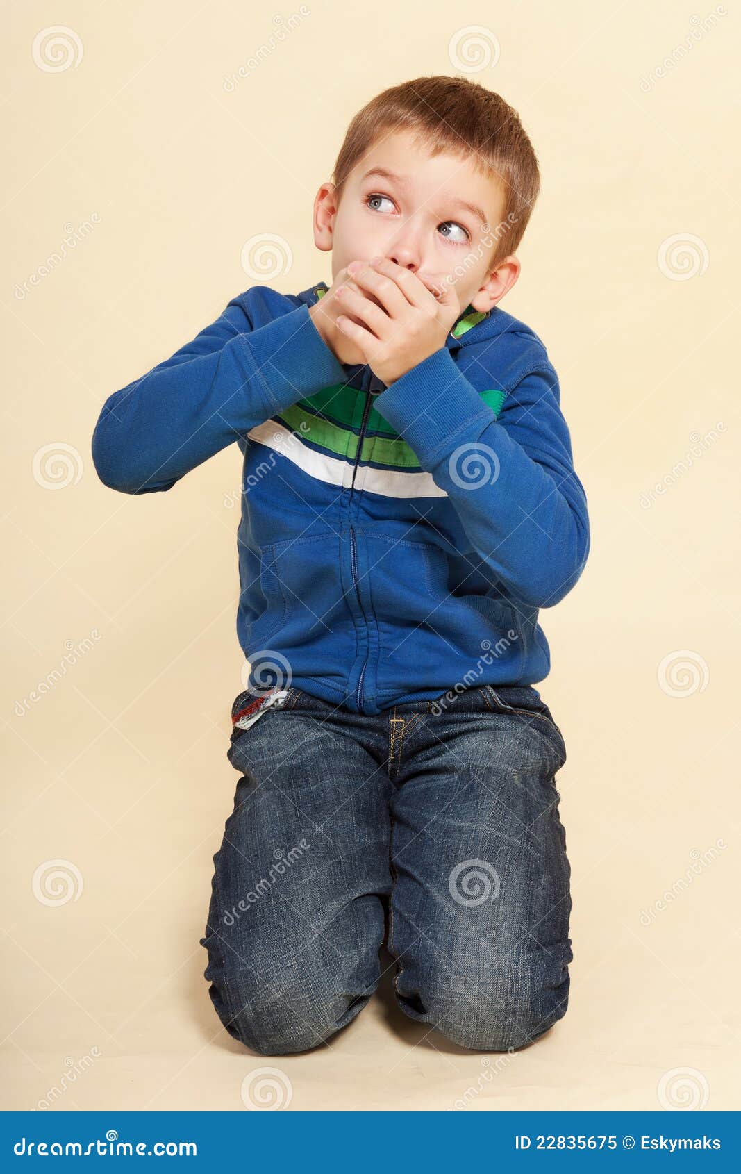 Oh shit, caught. Young boy with hands over his mouth isolated on neutral background. Facial expressions concept.