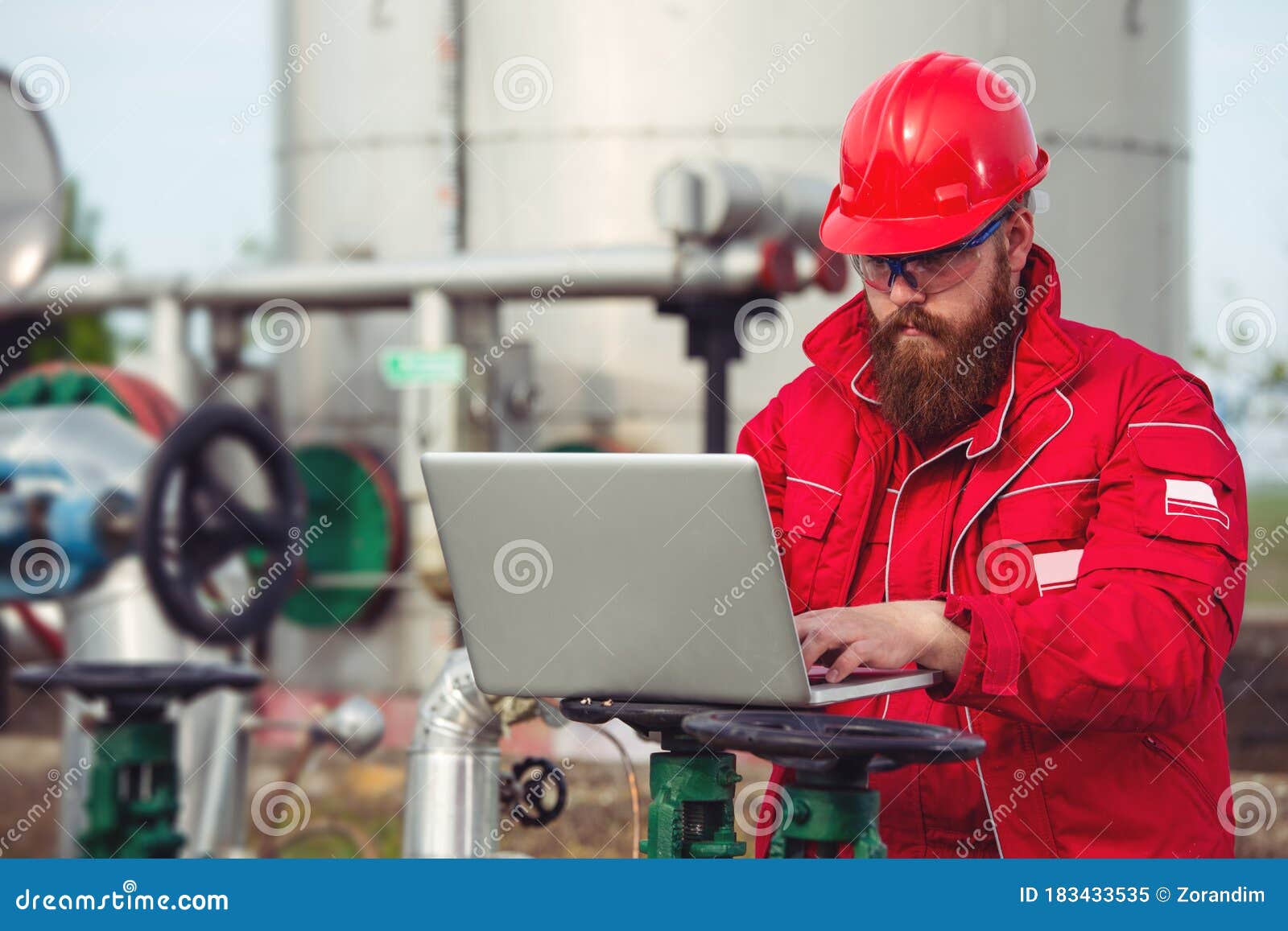 Oil Industry of an Engineer Making a Report on a Computer. Stock Image