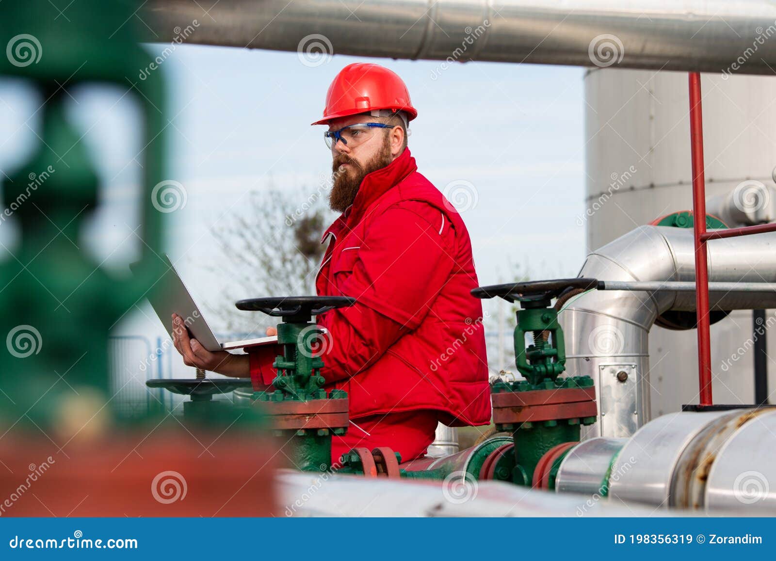 Oil Industry of an Engineer Making a Report on a Computer. Stock Image