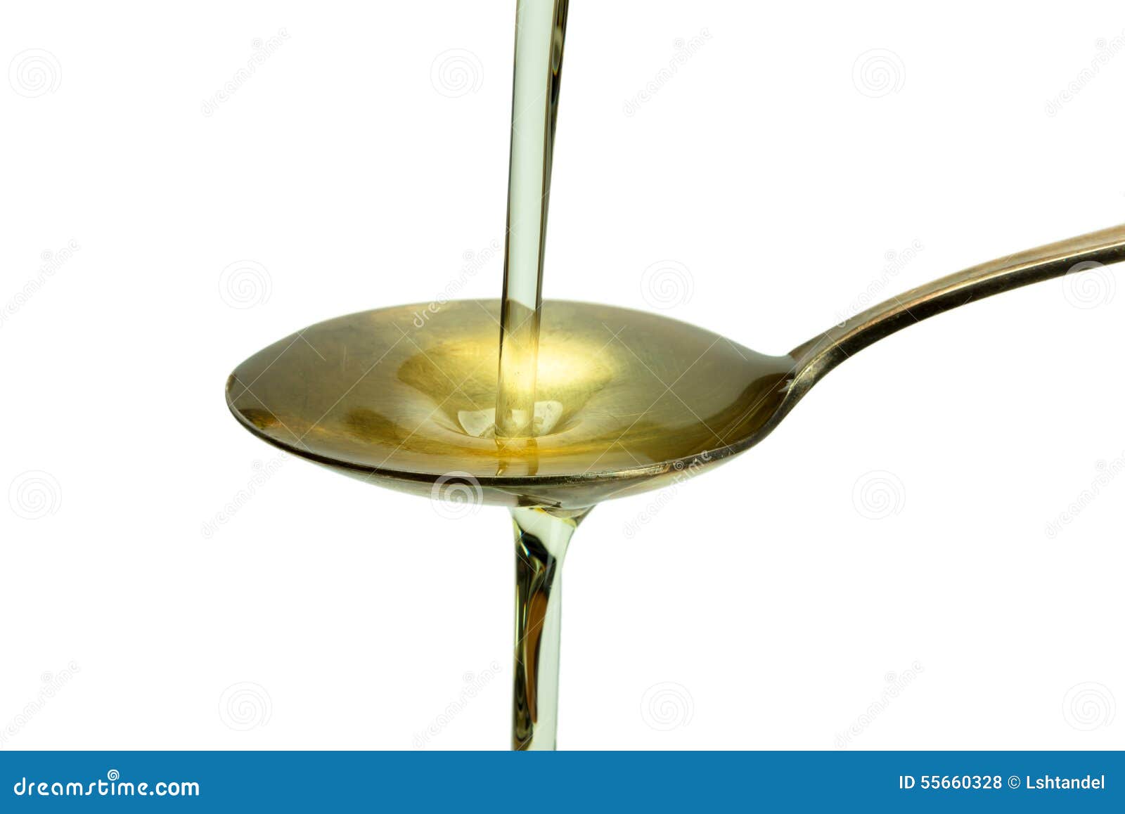 Oil Poured into the Old Vintage Spoon and Overflows Stock Photo Image