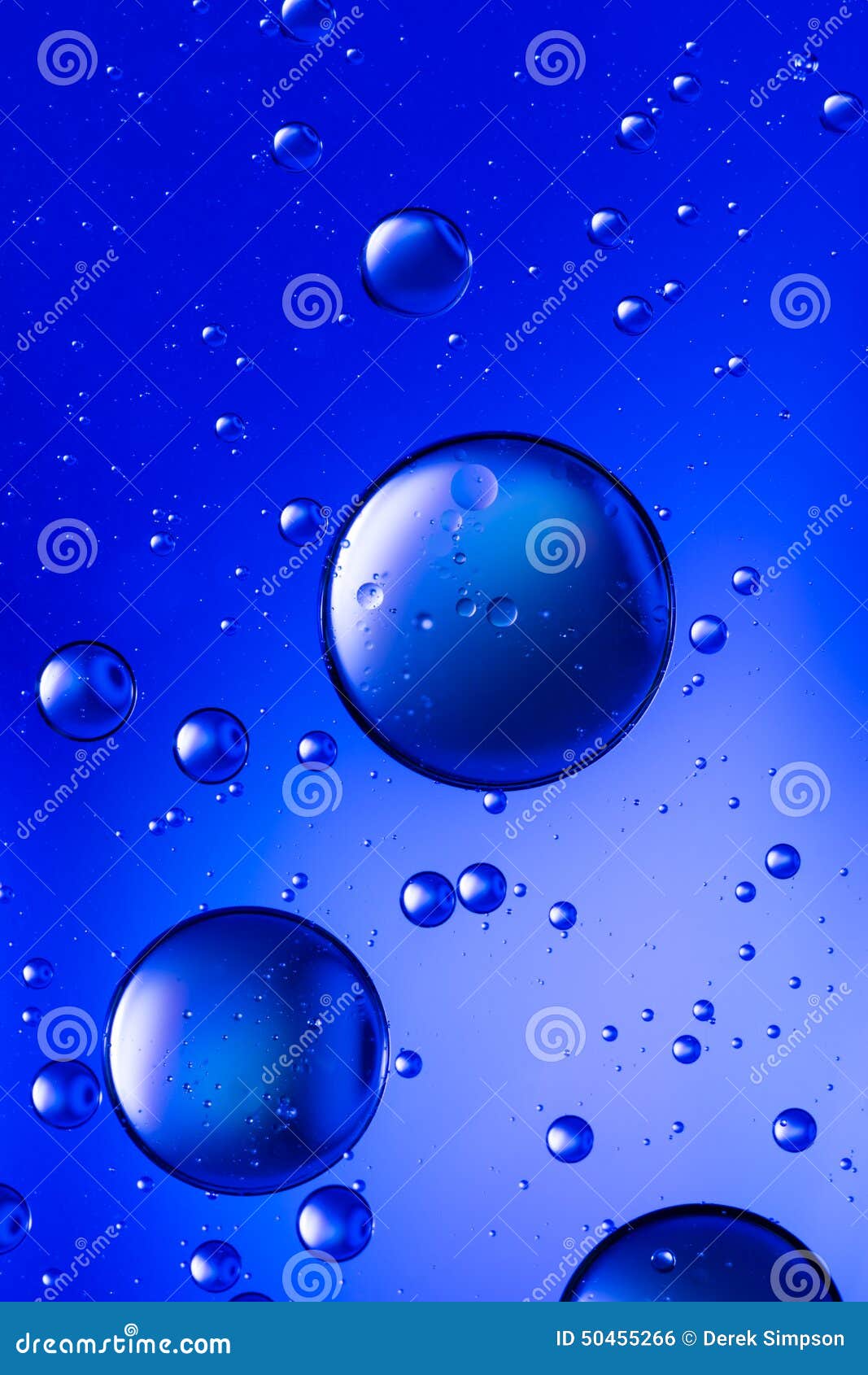 Oil and water, vivid blue. Oil and water abstract in vivid blue, creating an effect like rising bubbles