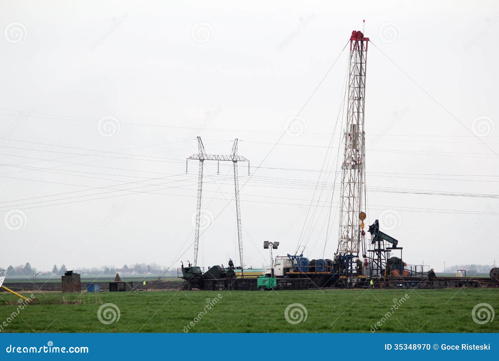Oilfield with Workers and Oil Drilling Rig Stock Photo Image of