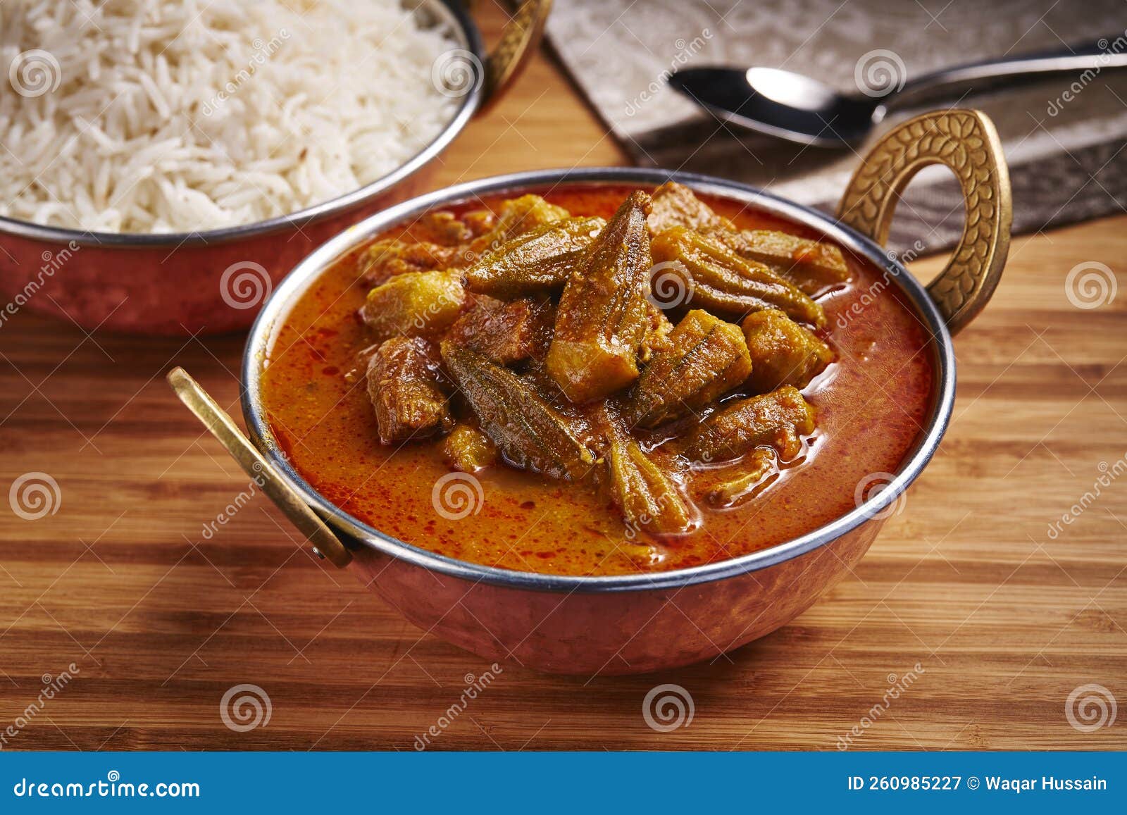 okra stew with white rice khoresht bamia or lady finger curry served in dish  on table side view of middle east food