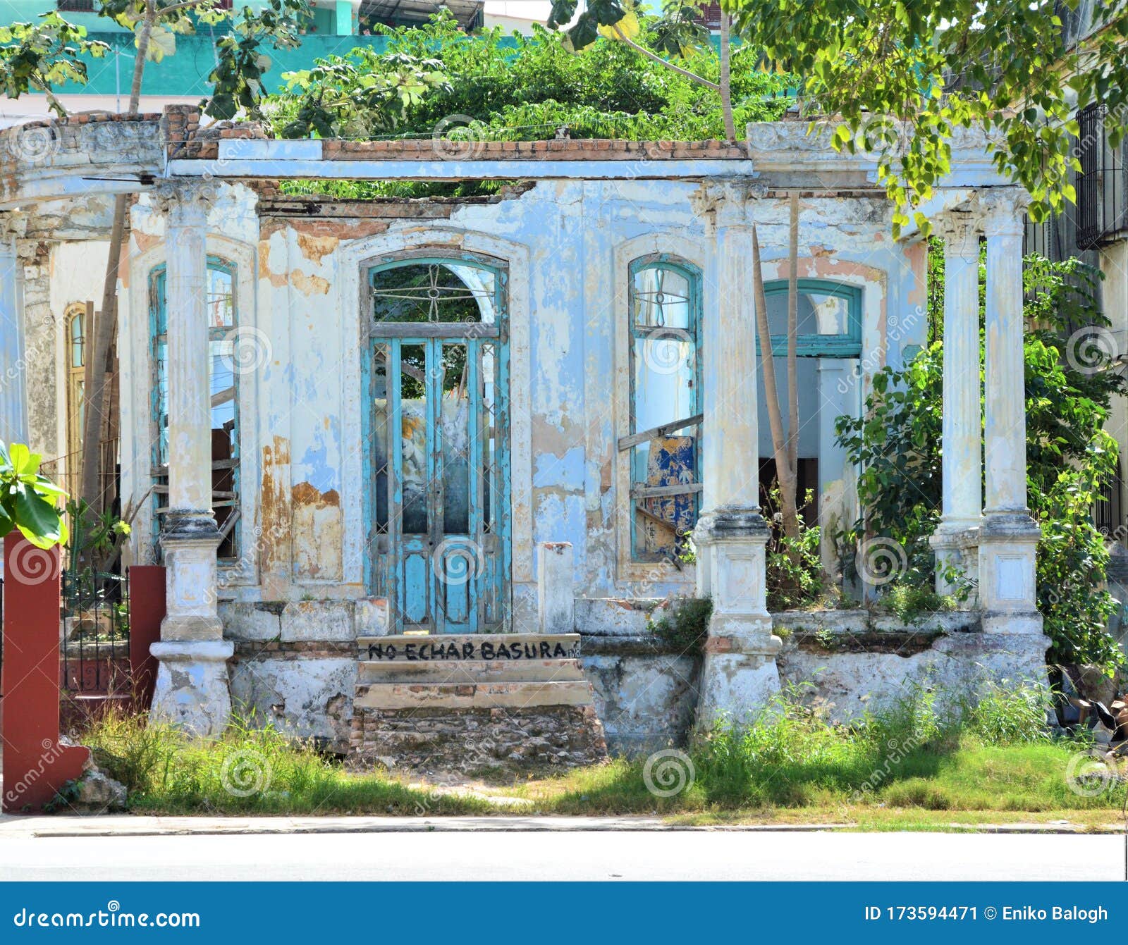 old abandoned roofless house with blue door and windows in havana, cuba