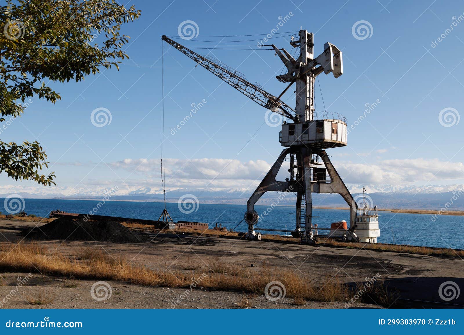 old abandoned soviet crane in port balykchy on issyk-kul lake at sunny autumn afternoon