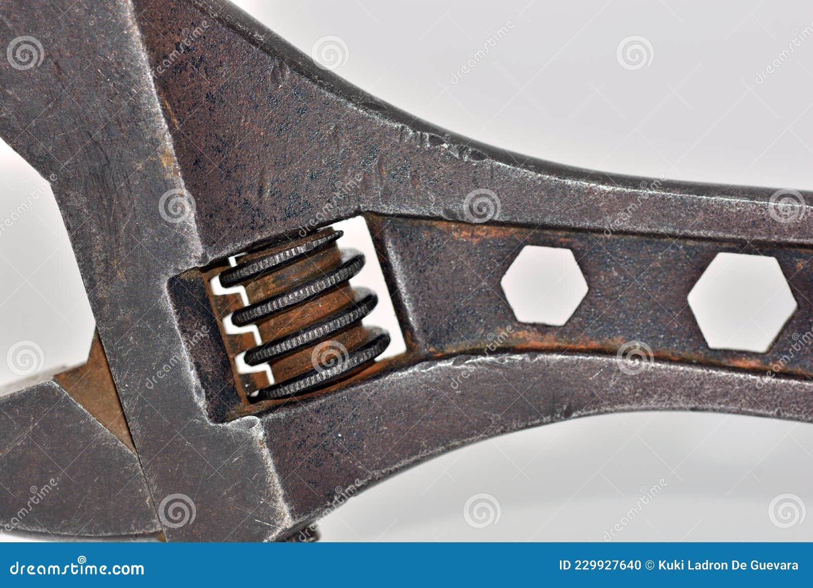 old adjustable wrench with a nut