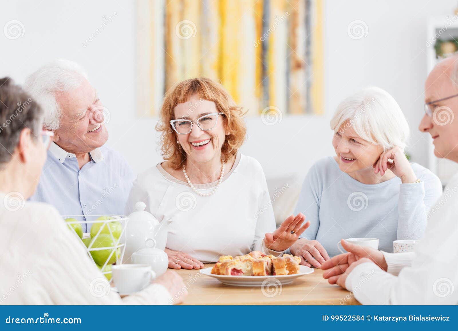 happy seniors chatting at cafe