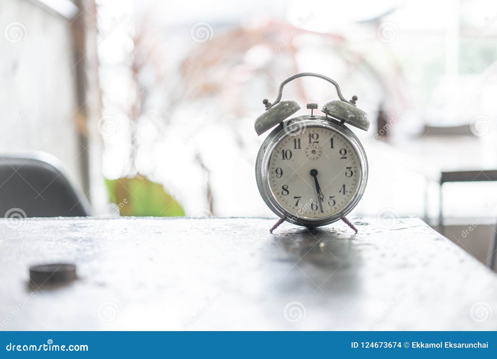 Old Alarm Clock on the Ancient Iron Table. Stock Photo Image of