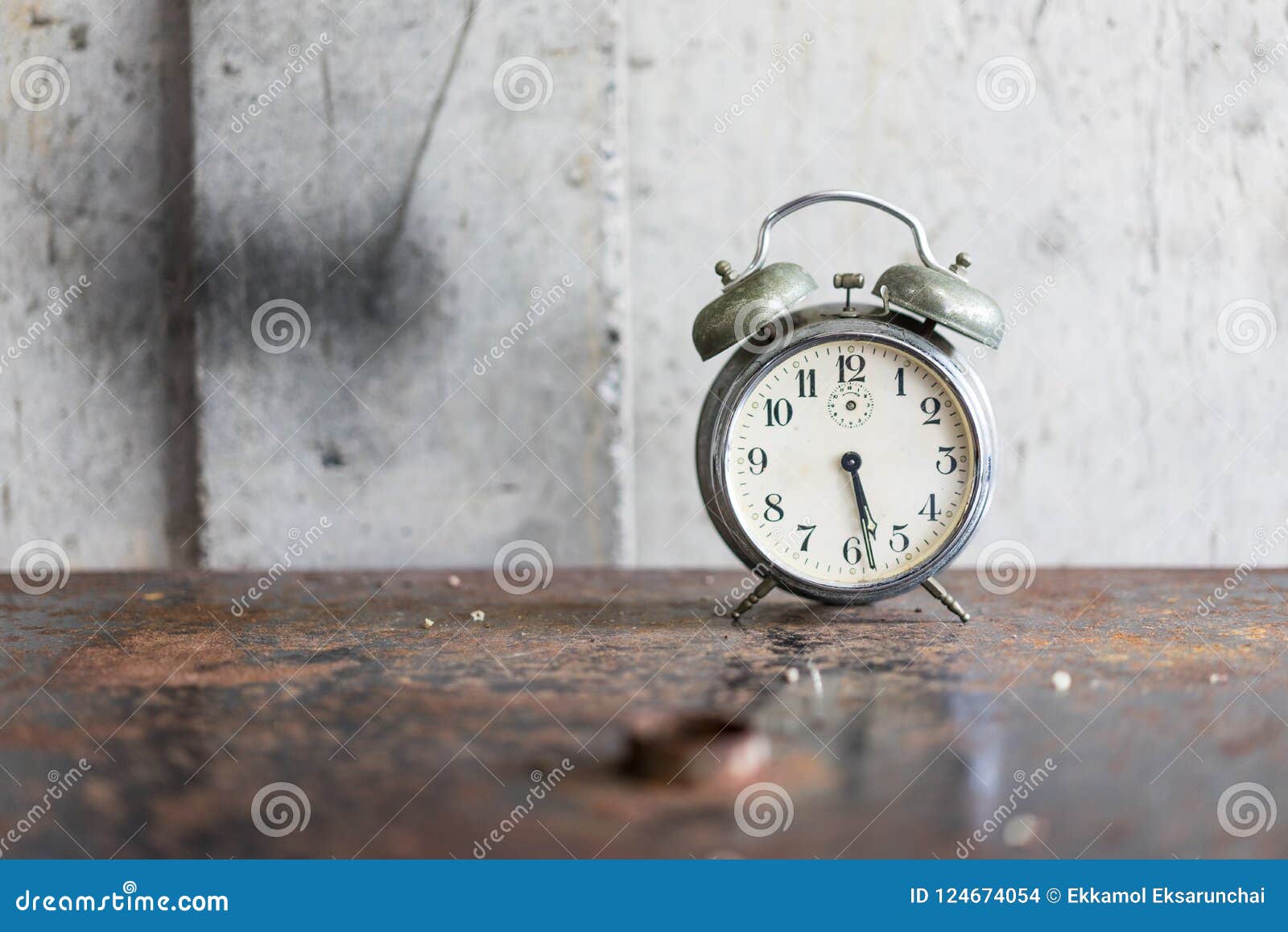 Old Alarm Clock on the Ancient Iron Table. Stock Photo Image of