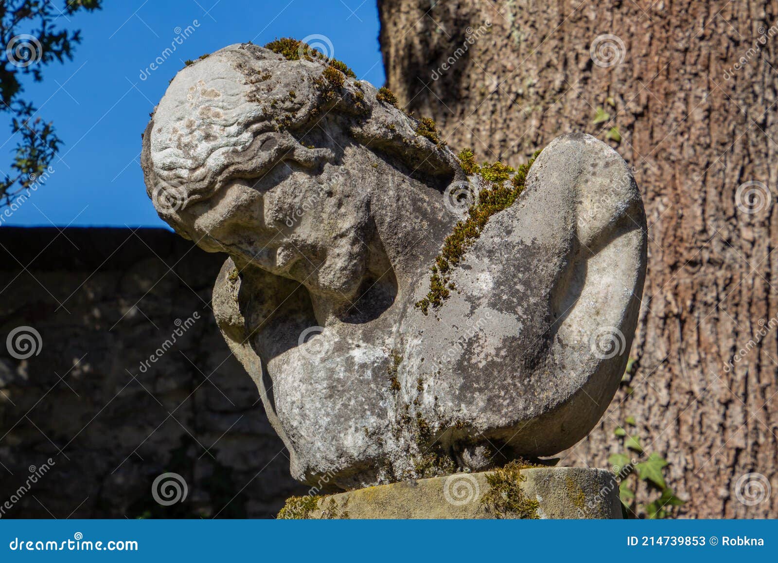 Old Ancient and Damaged Statue of Jesus Covered with Moss Stock Image