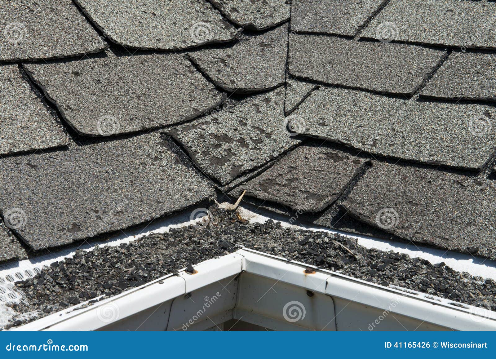 old bad and curling roof shingles on a house or home
