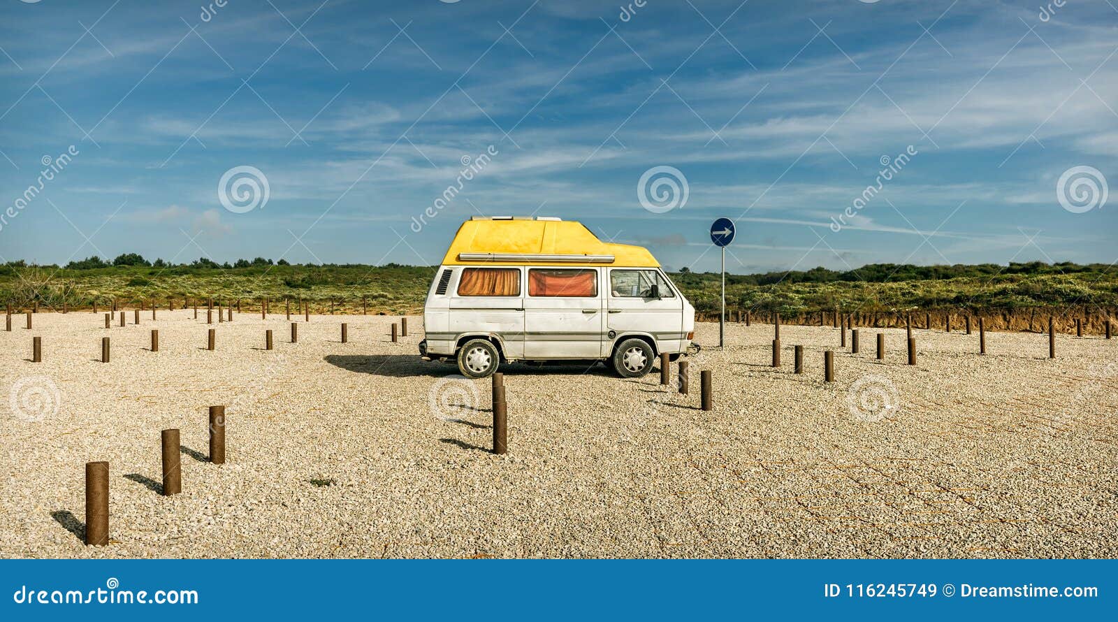 old beach van at a beach parking lot
