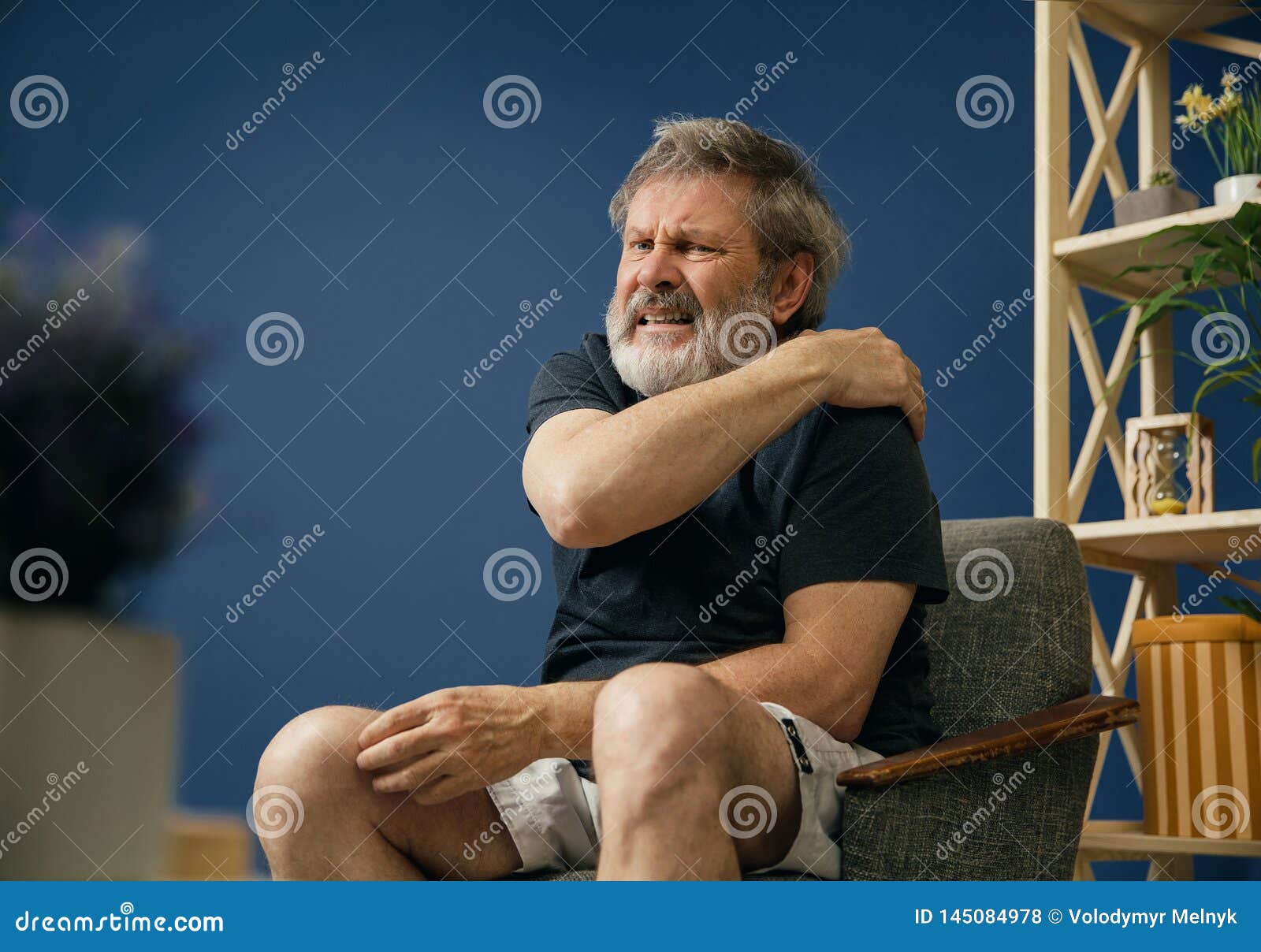 old bearded man suffering from pain