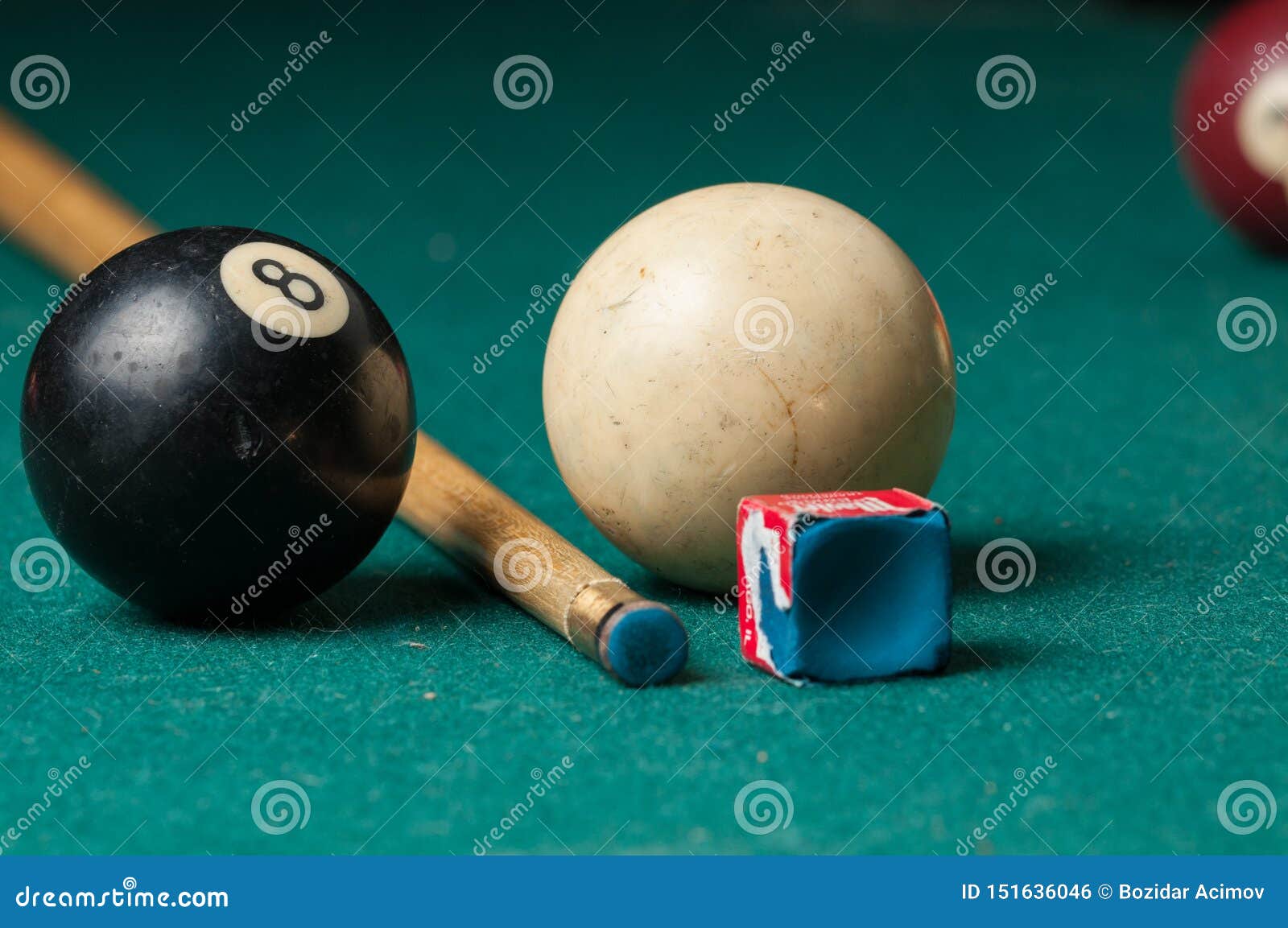 old billiard ball 8 and stick on a green table. billiard balls  on a green background.black and white