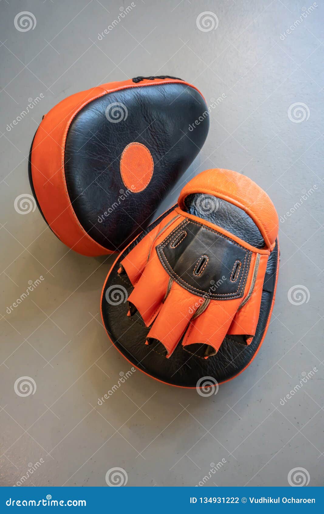 Old Black and Orange Boxing Gloves on Grey Concrete Background Stock