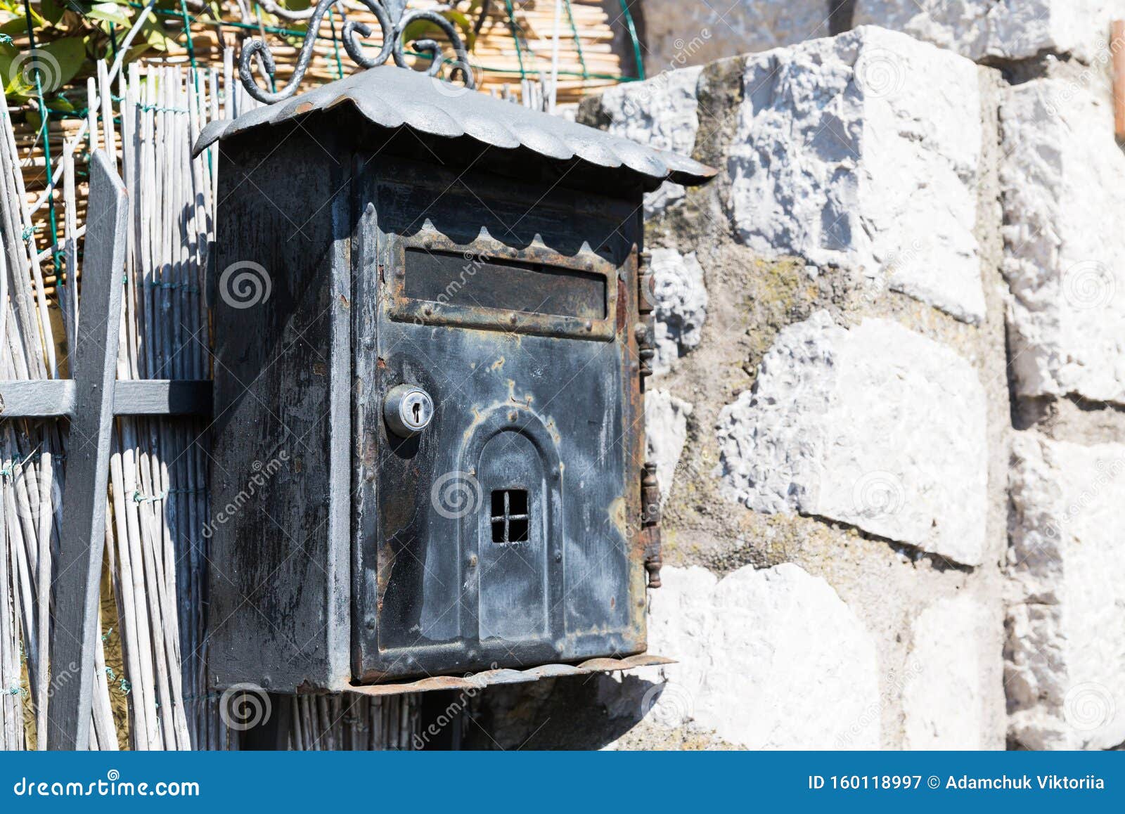 old black poste italiane mailbox on grey grungy wall in capri, italy