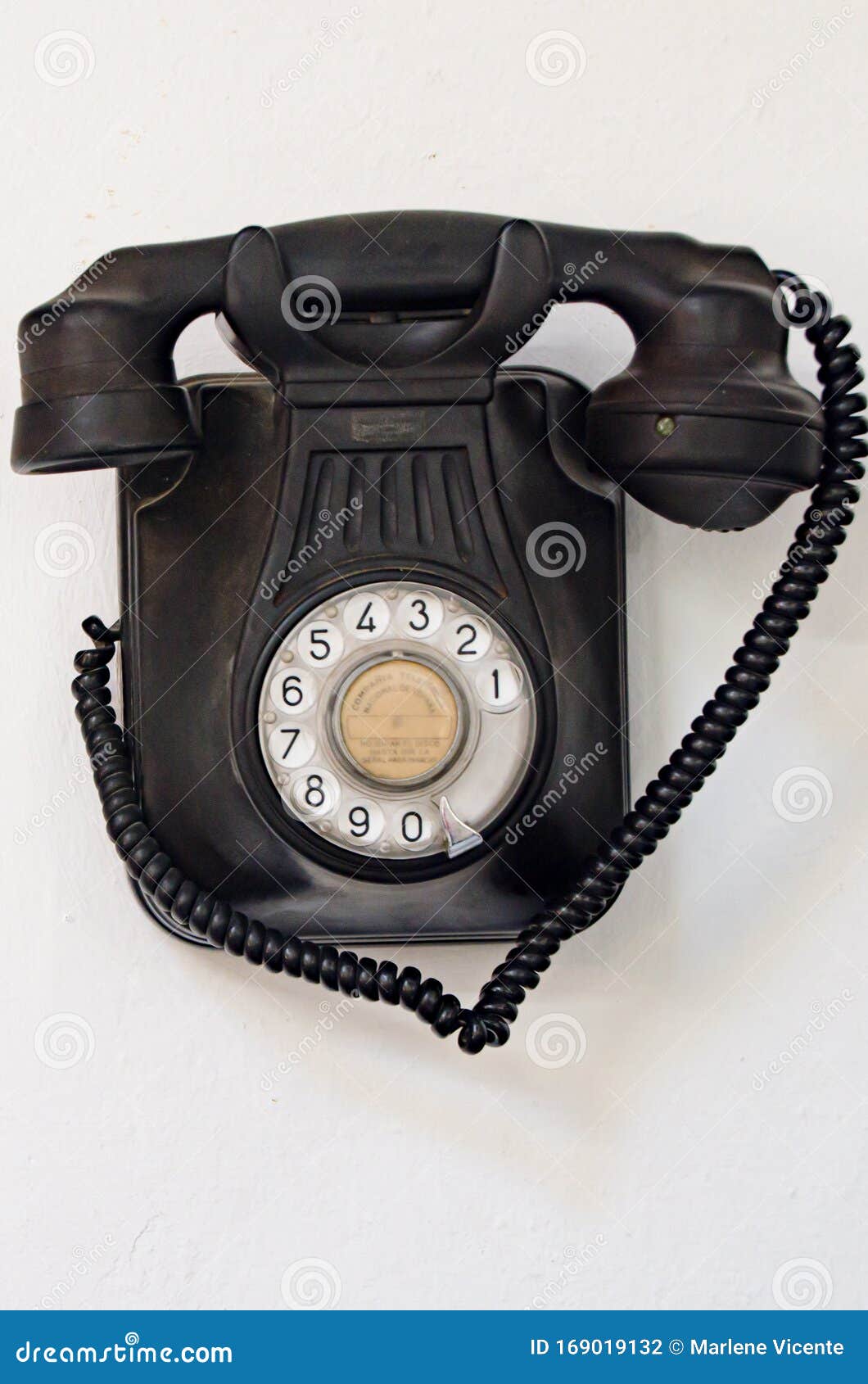 Old Black Telephone Hanging on a White Wall Editorial Photography