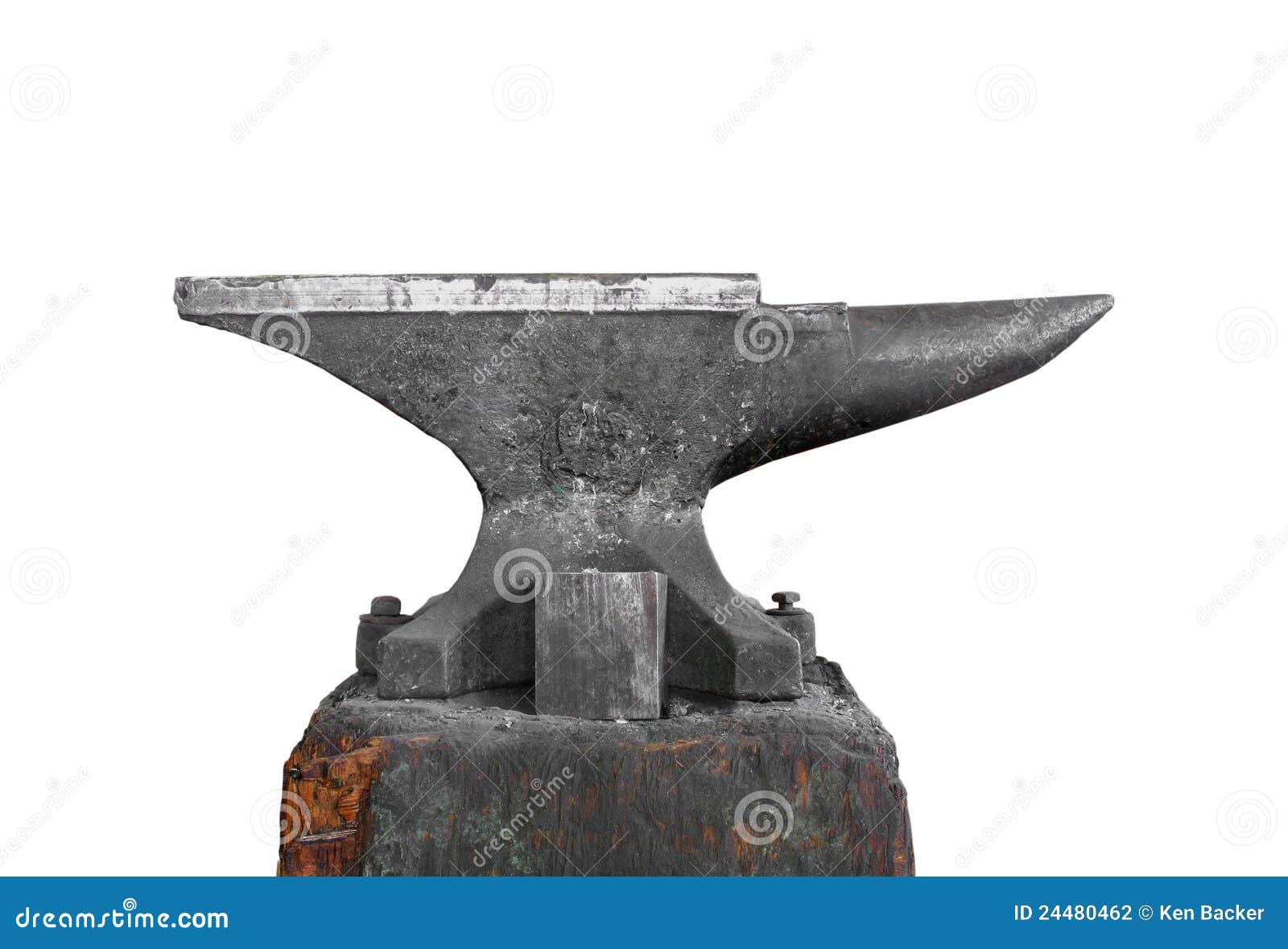 Old large blacksmith anvil on a base of an old block of wood. Isolated 