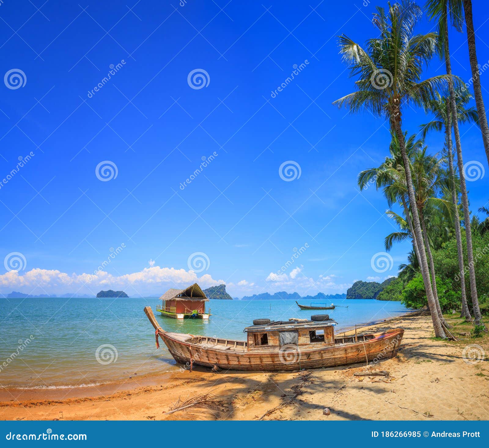 old boat at beach with palm trees in koh yao noi, thailand