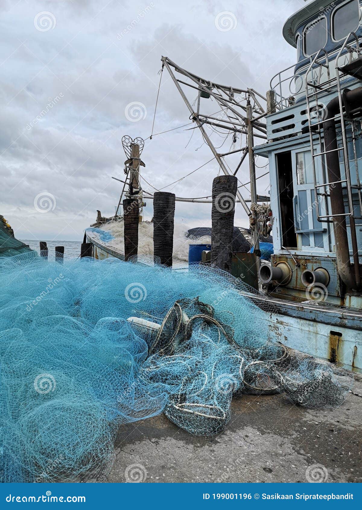The Old Boat and Fishing Nets Drying on the Floor.Trawl of Fisherman or Net  on the Shore at Fisherman Village before Storm Stock Photo - Image of busy,  drying: 199001196