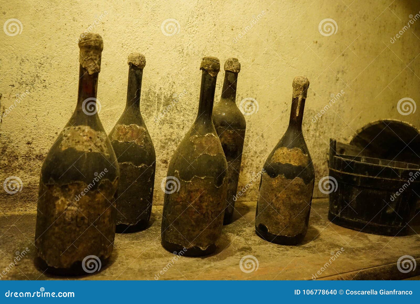 Old bottles of dusty wine stock photo. Image of winery 106778640