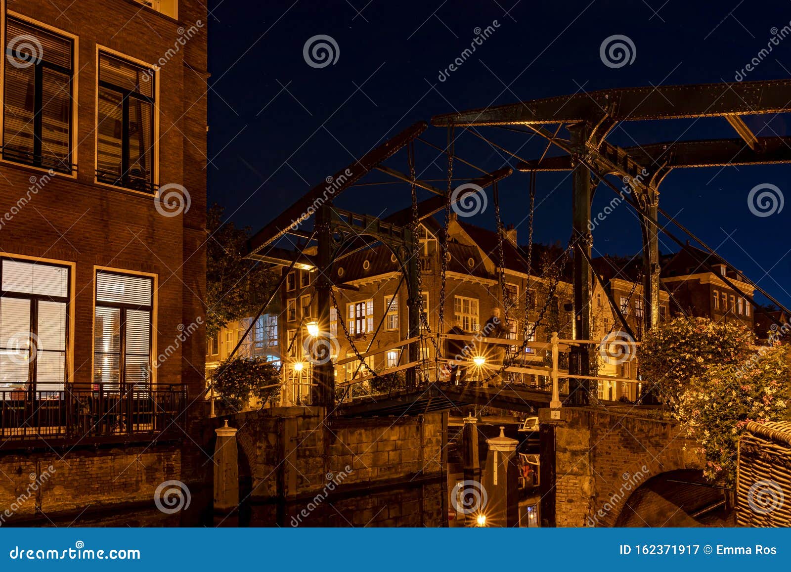 an old bridge the kerkbrug on the oude rijn river, lit by beautiful lamp-posts, leiden, the netherlands