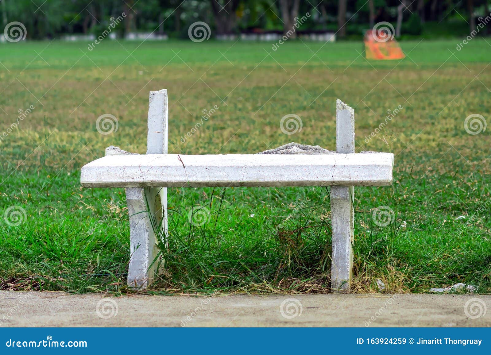 Old and Broken Long White Cement Bench for Relaxing after the Exercise beside the Exercise Yard