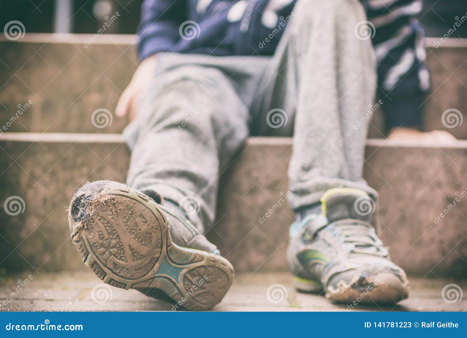 old broken shoes of a little boy as a  for child poverty