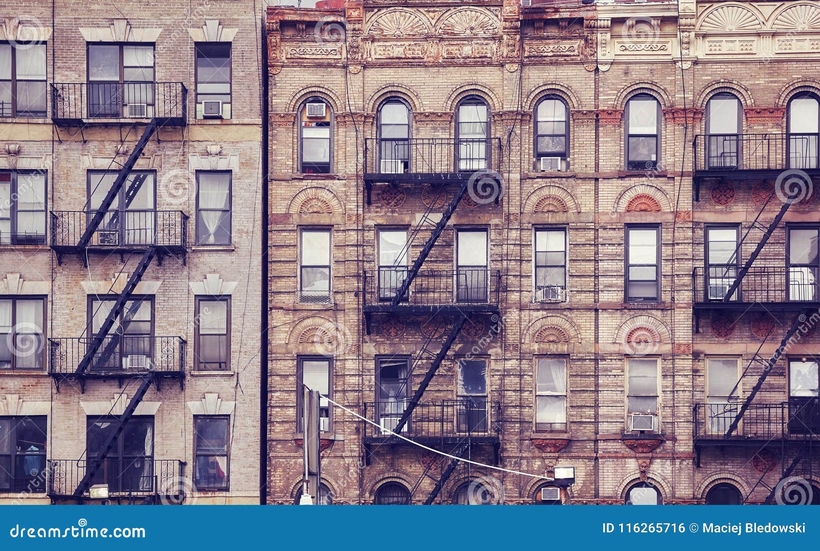 old buildings with fire escapes in new york city.