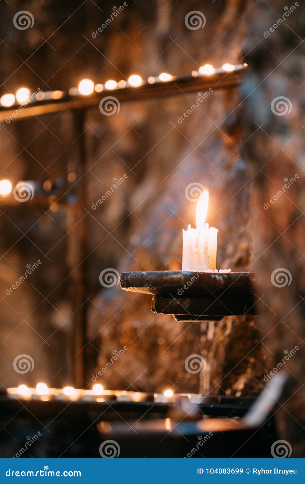 Old Candle in Church. Candle Light Flame Near Ancient Wall Stock Image