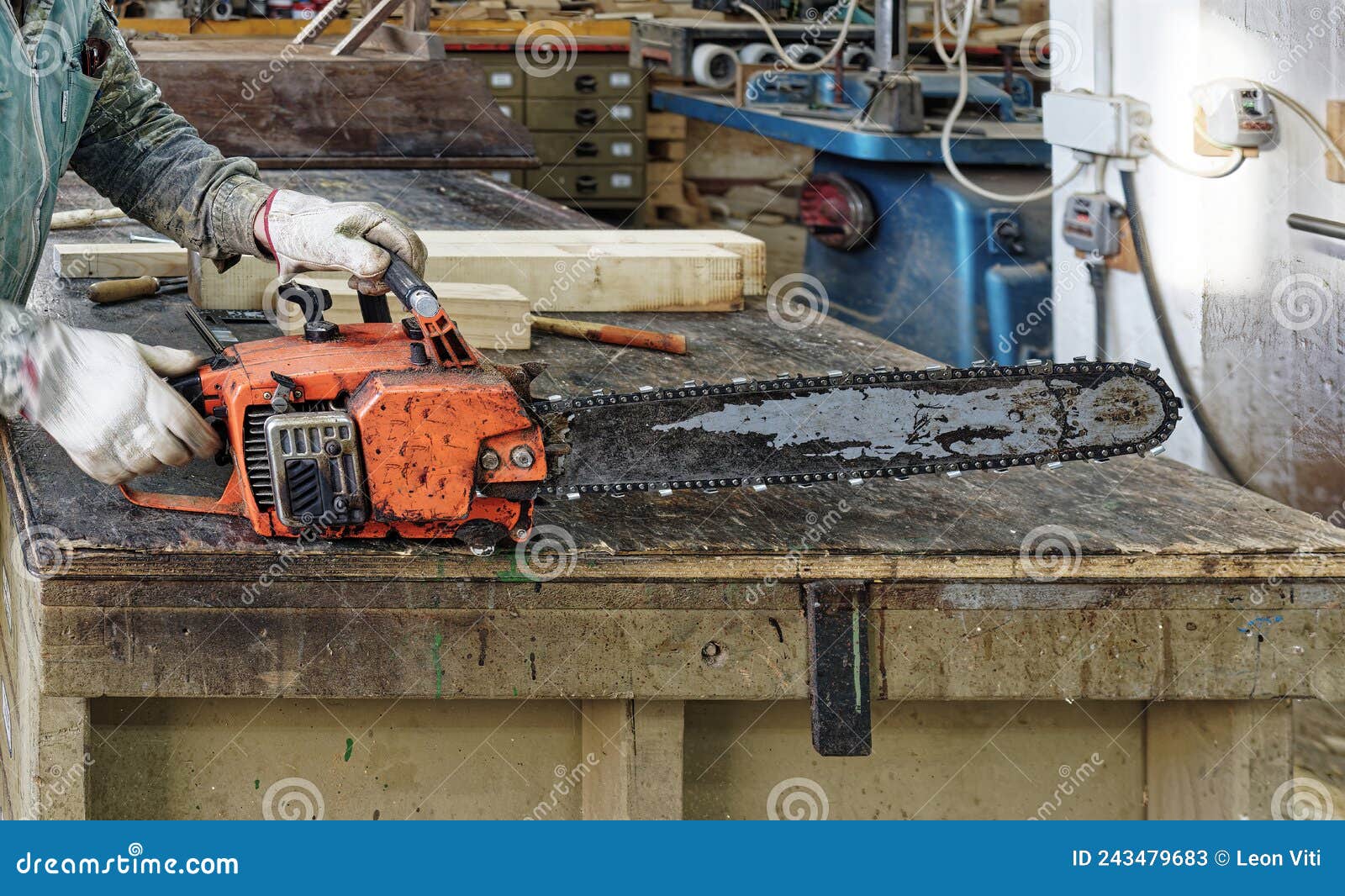 Old chainsaw in a factory stock image. Image of dirty 243479683