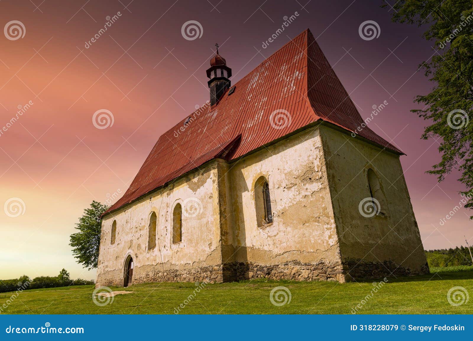 old church in the summer field. dobronice u bechyne, czech republic