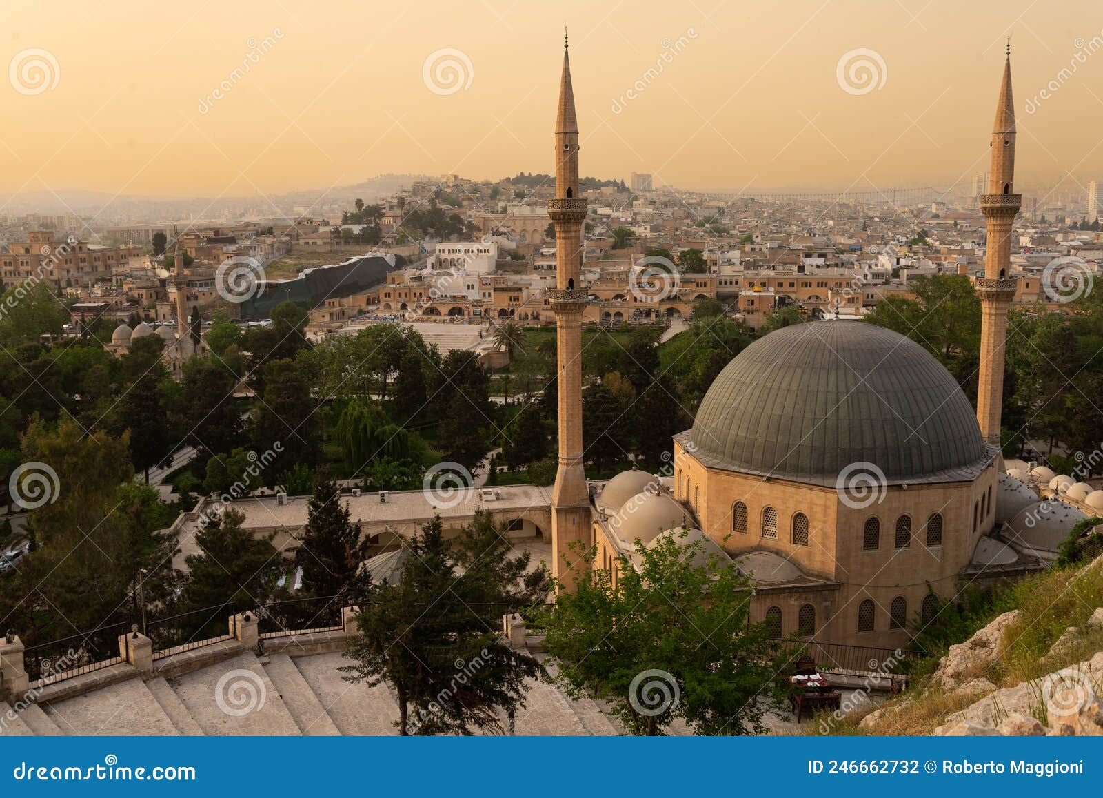 old city of sanliurfa, turkey. mevlidi halil cami mosque and minarets at dusk.
