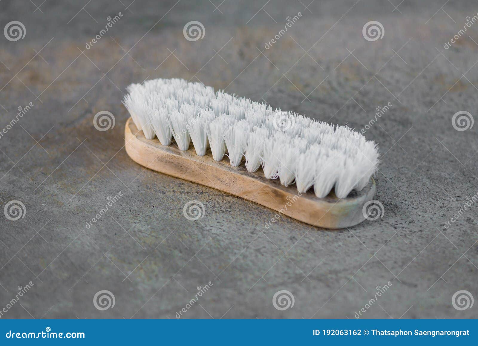 Old Cleaning Brush or Washing Brush on Concrete Floor Stock Photo