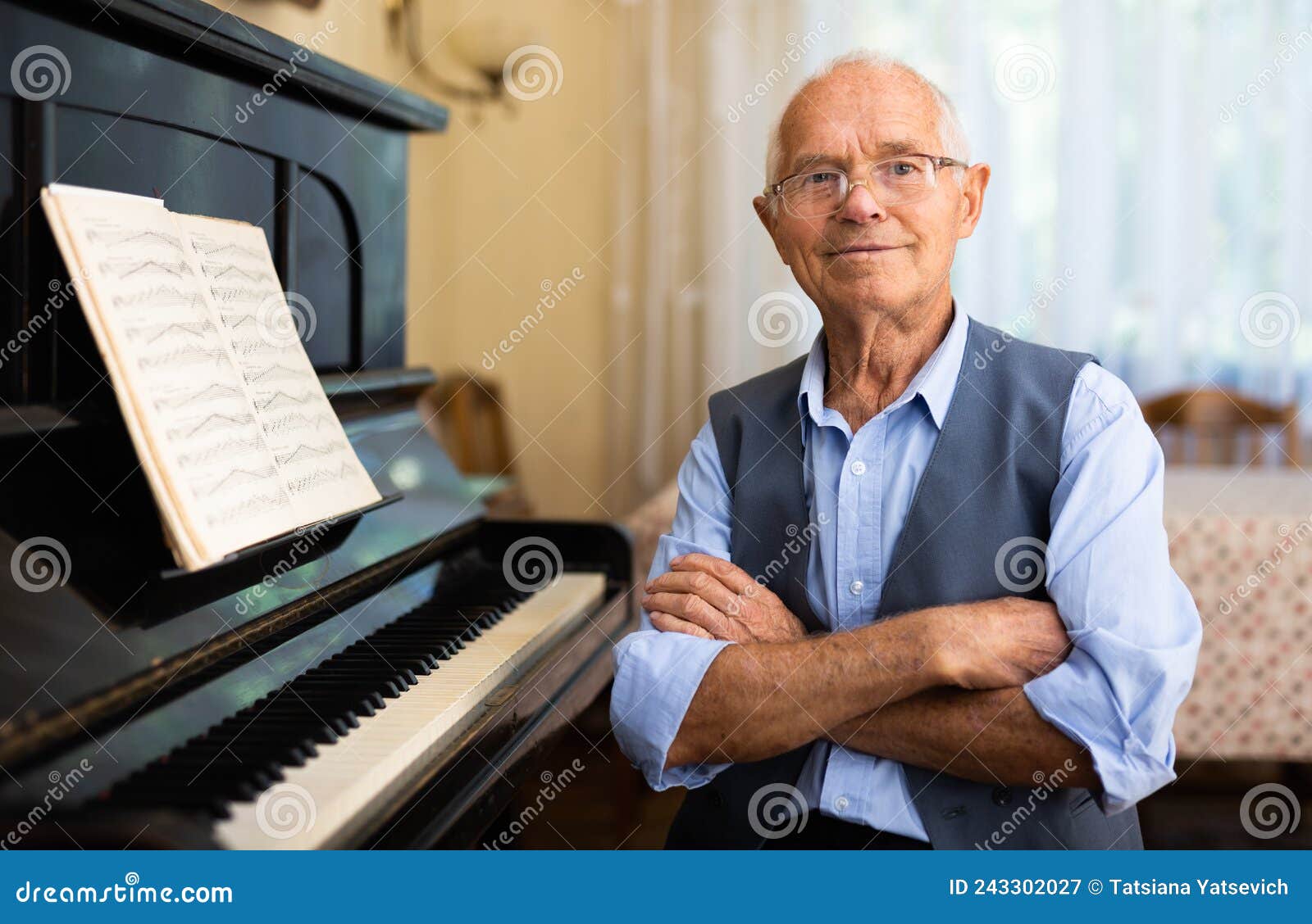 old compositor sitting beside piano