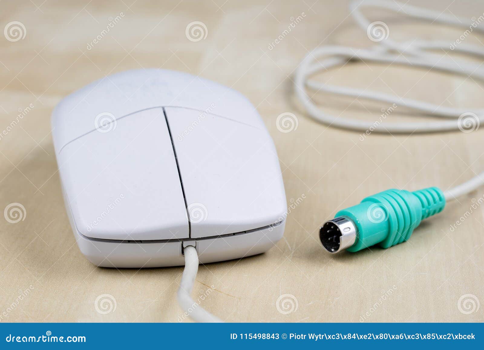 Old computer mouse running on the principle of a ball on a wooden table