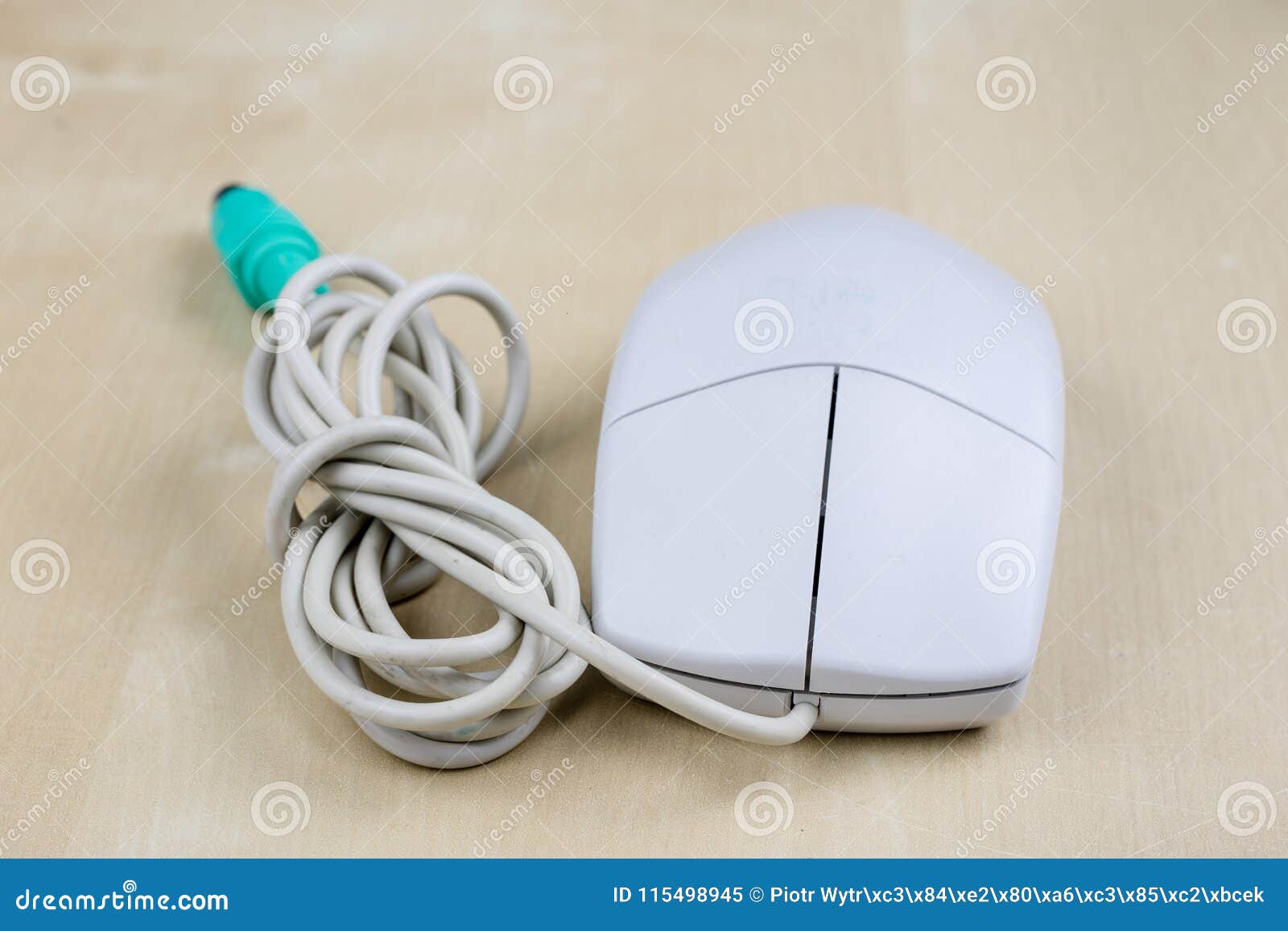 Old Computer Mouse Running on the Principle of a Ball on a Wooden Table