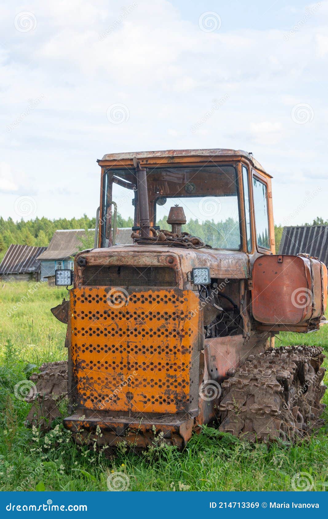 A Tractor And A Bulldozer Compact The Cut Grass In A Silage Trench ...