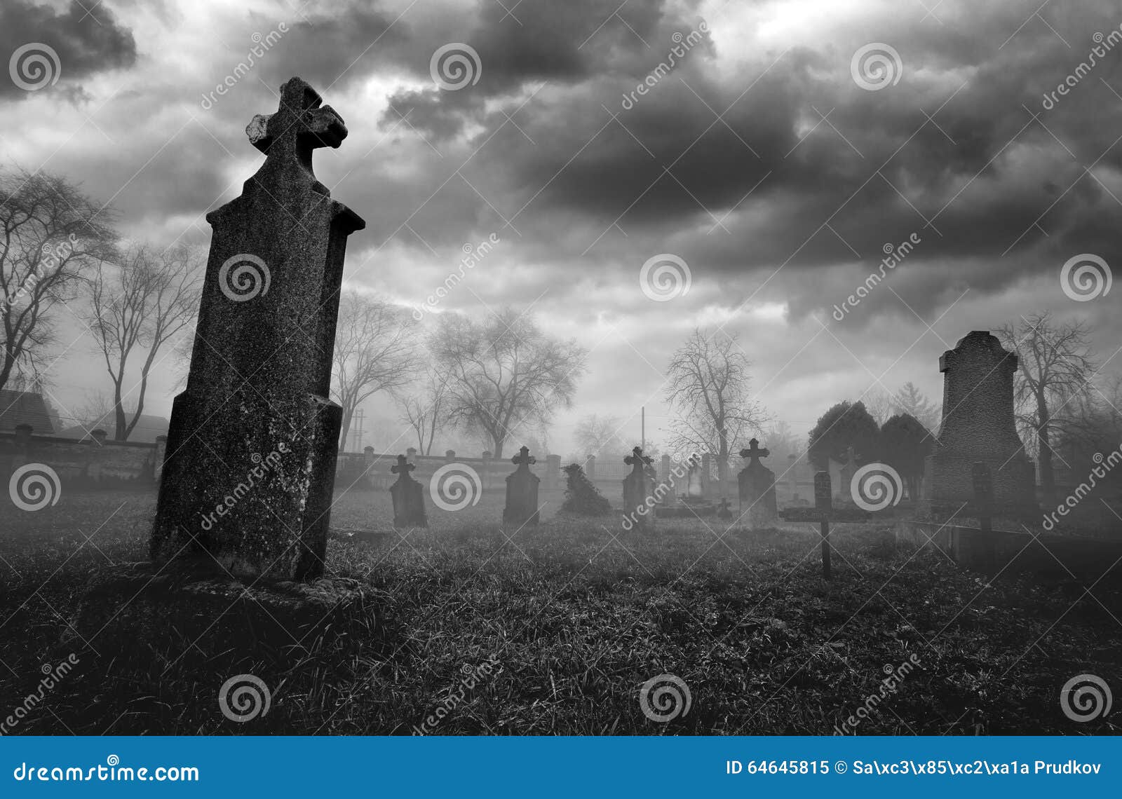 old creepy graveyard on stormy winter day in black and white