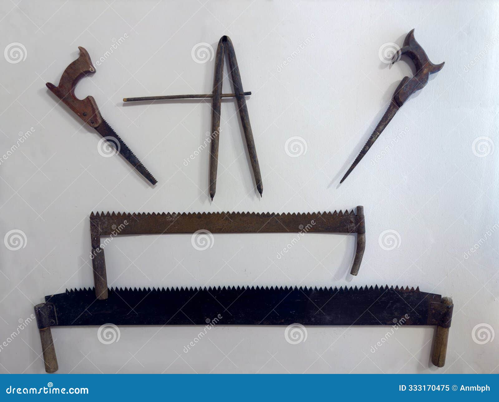old crosscut saws and two-man saws hanging on wall