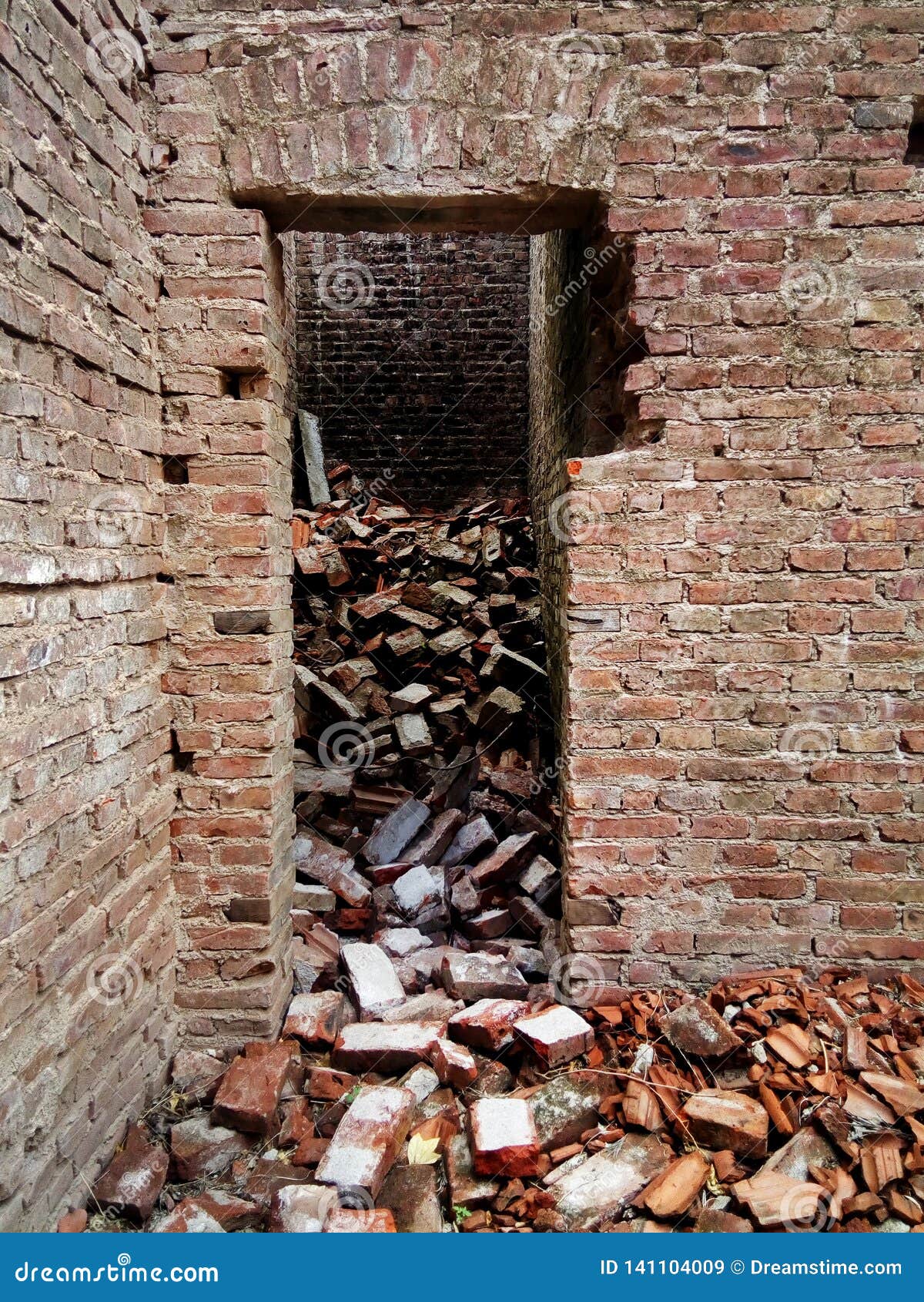 old crumbling brick house in ruins