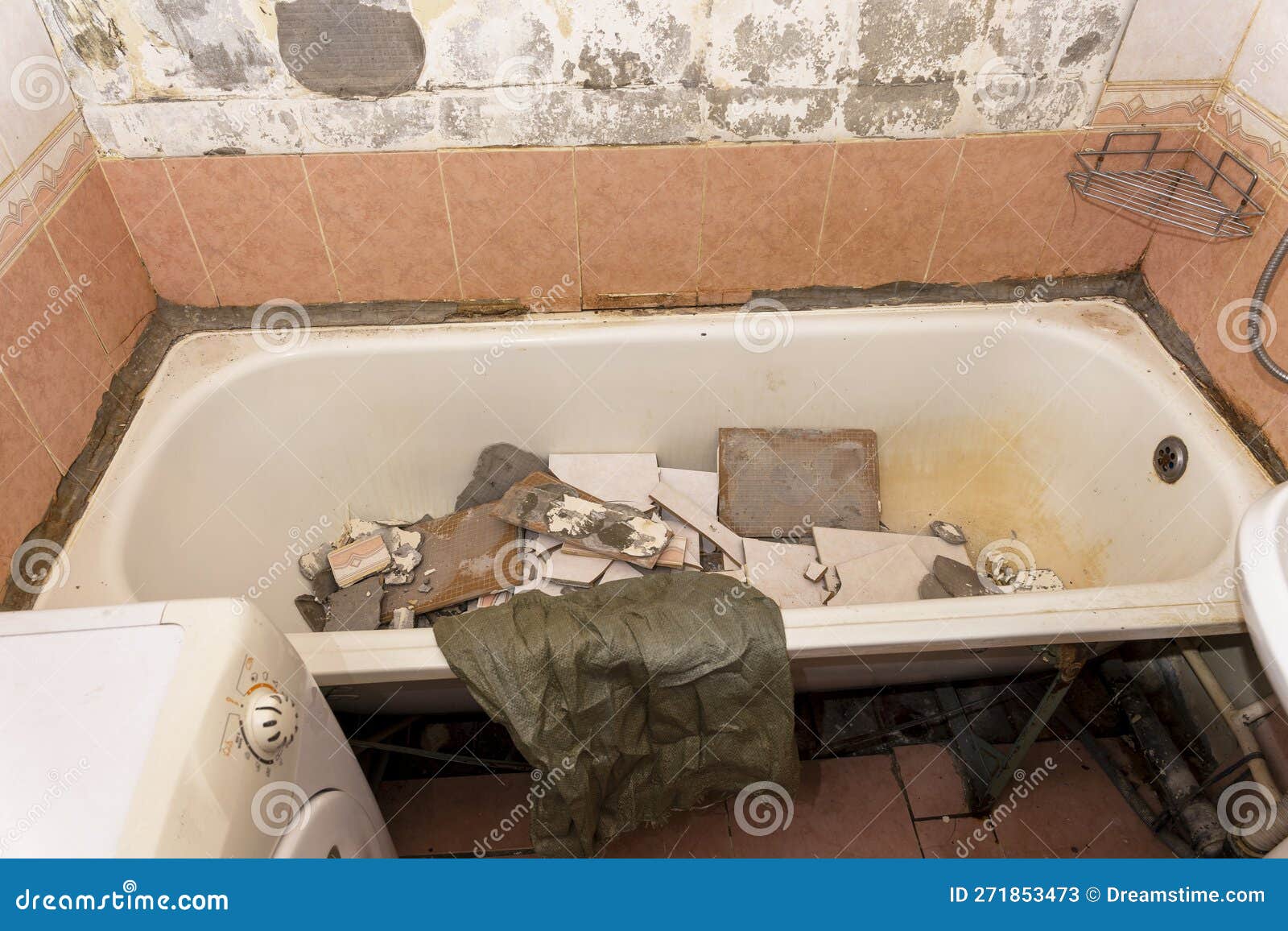 An Old Dirty Shabby Bathroom with Fallen Tiles. Repair Stock Image