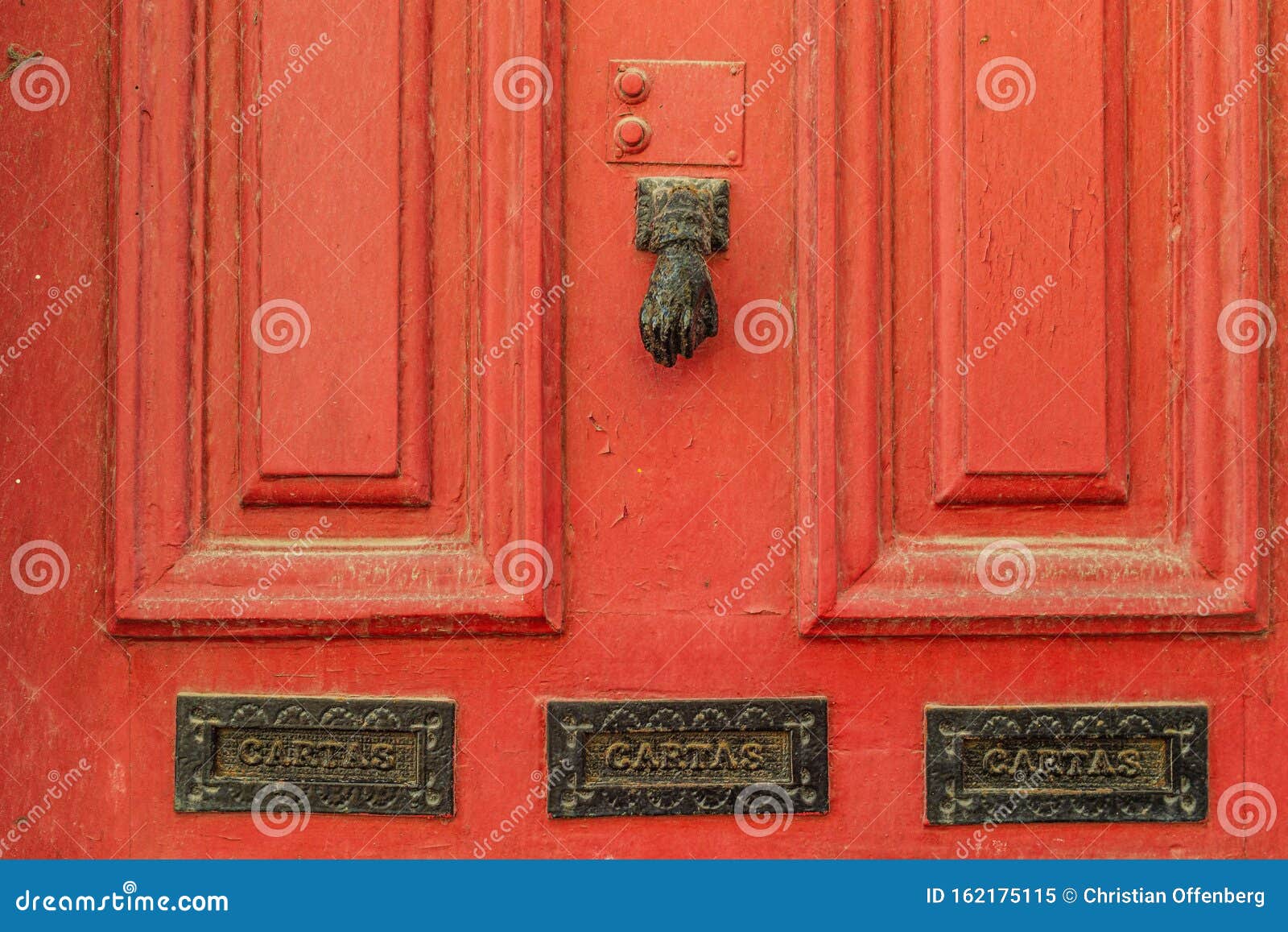 an old red door with on a street in the center of porto. portugal