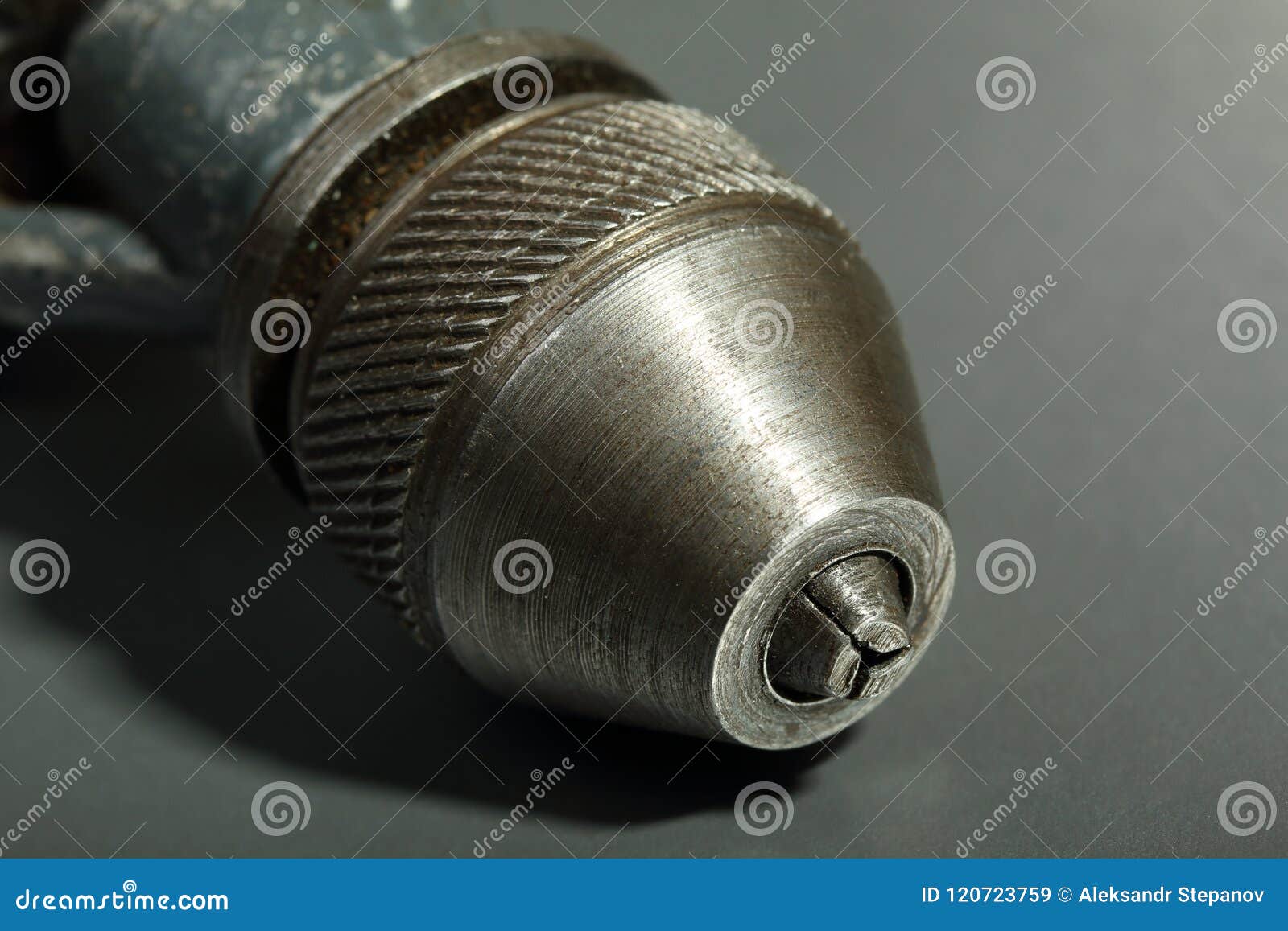Old Drill Chuck on a Gray Background. Details of an Old Drill Stock