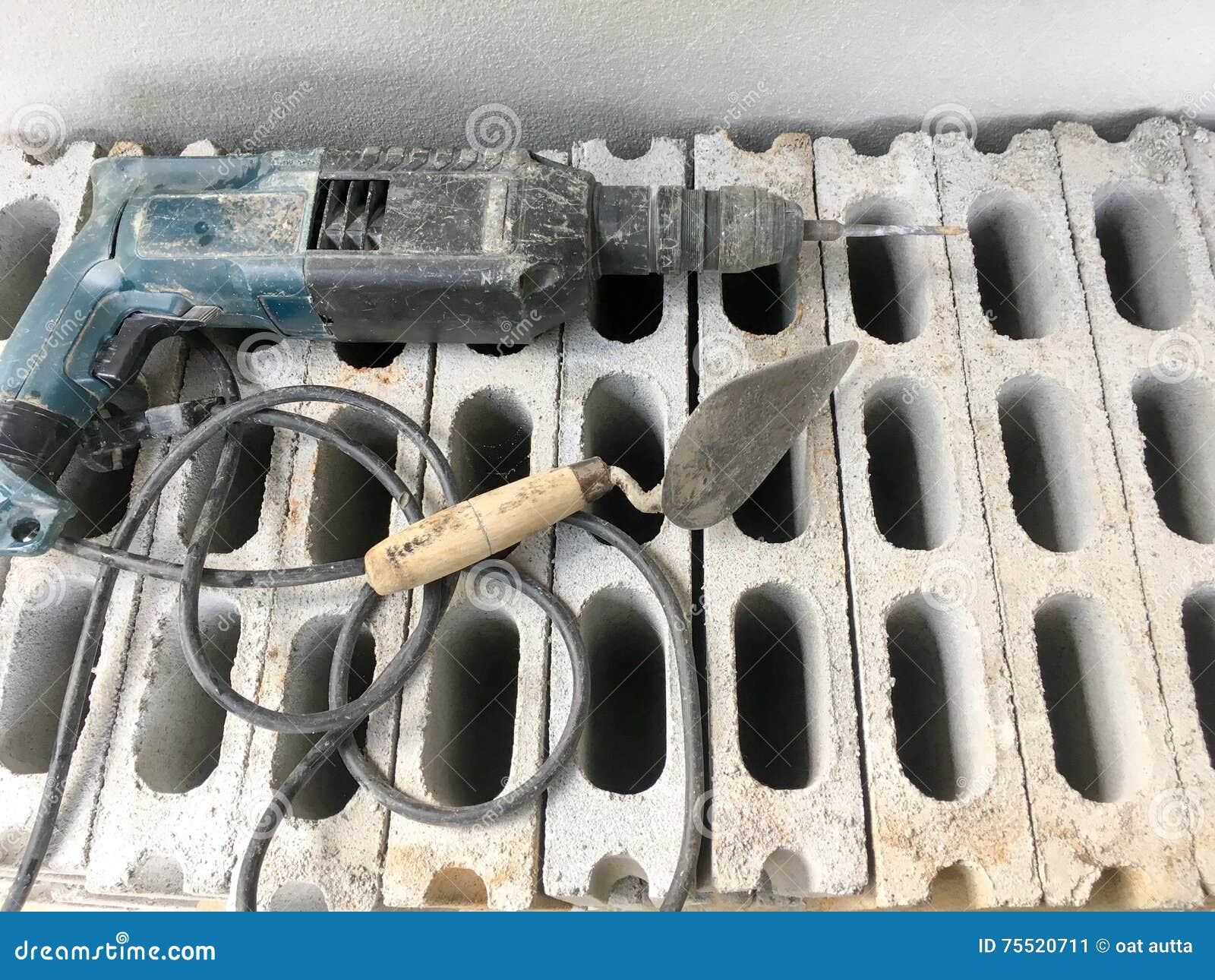 Old Electric Drill on Gray Brick Wall Background Material of