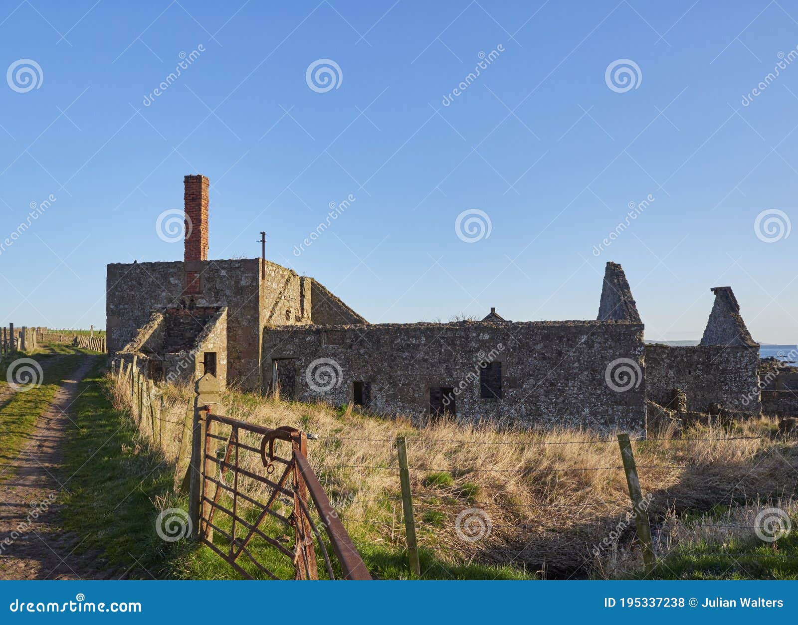 old farm buildings lie abandoned near the east coast of scotland at usan.