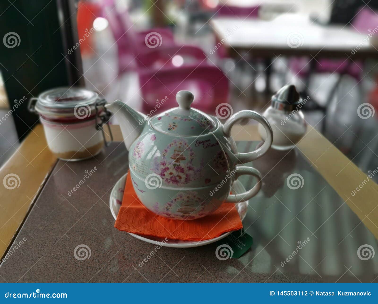 Old Fashioned Teapot with Tea Cup and Sugar on Table Stock Photo