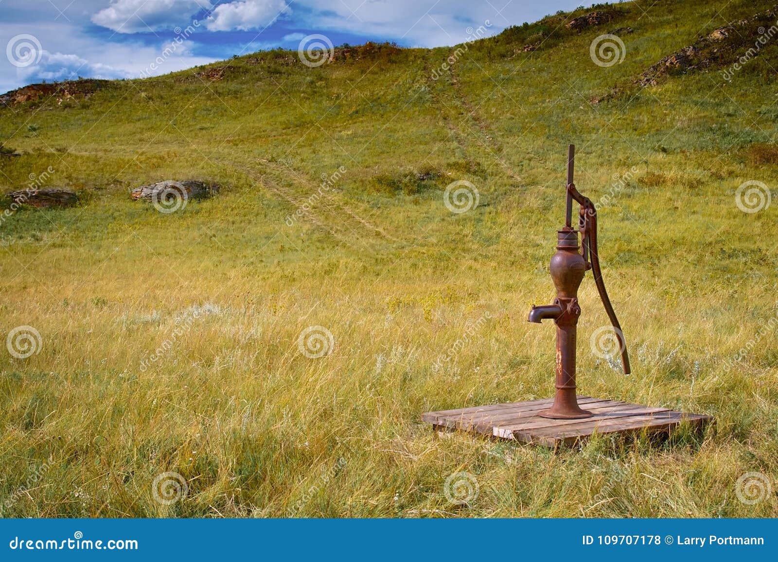 old fashioned water pump out in a field