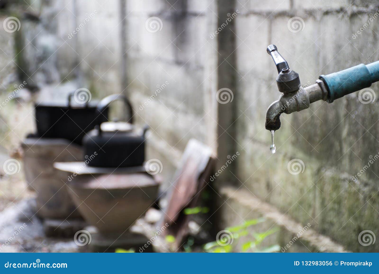 Old Faucet With Water Leaking Drop To The Ground Stock Photo